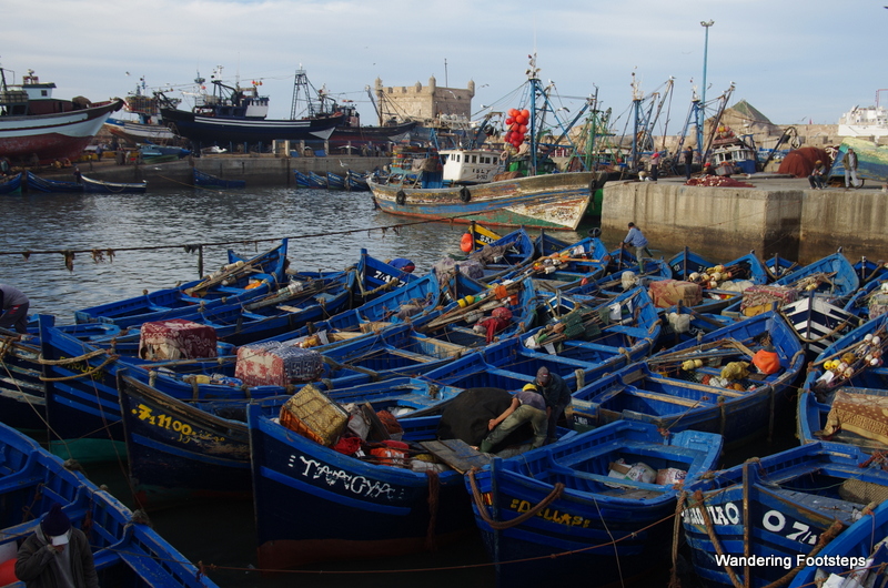 Blue fishing boats bobbing in front of Essaouira's Skala du Port.