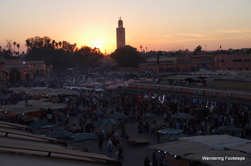 The sun sets over the Koutoubia Mosque and the Djemaa el Fna.