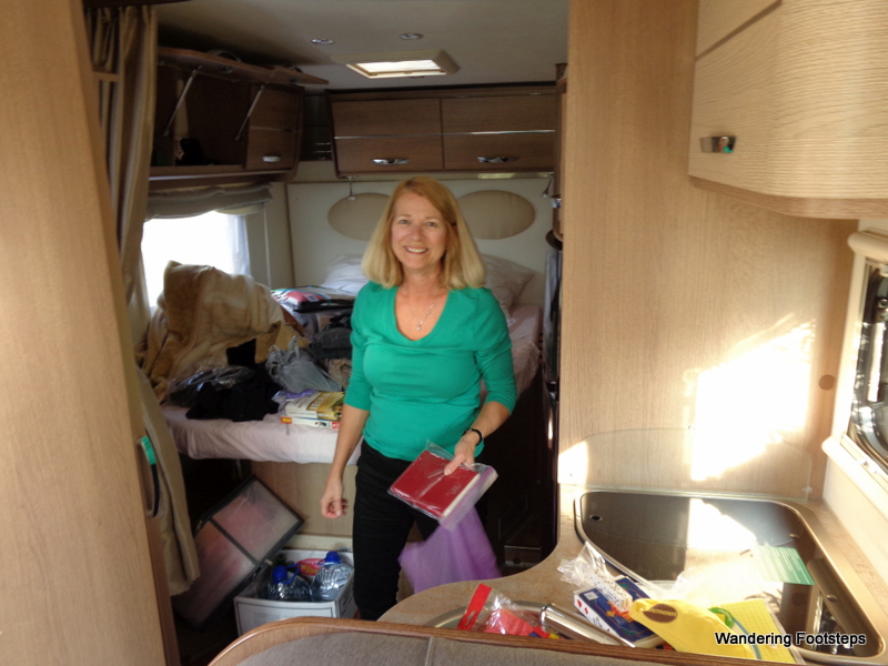 Mom unpacking and organizing their rental camper van.