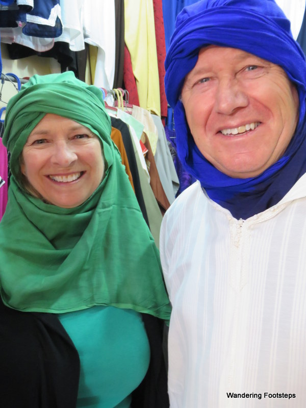 Mom and dad get dressed up like Moroccans in a Marrakech shop.