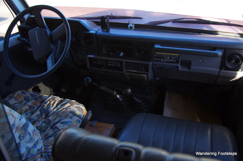 View of dashboard from bed in the back box of vehicle.  You can pass through the windows to access the cab from the box.