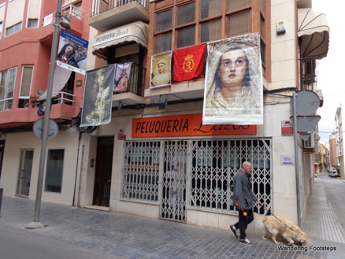 Religious banners hung from balconies and businesses.