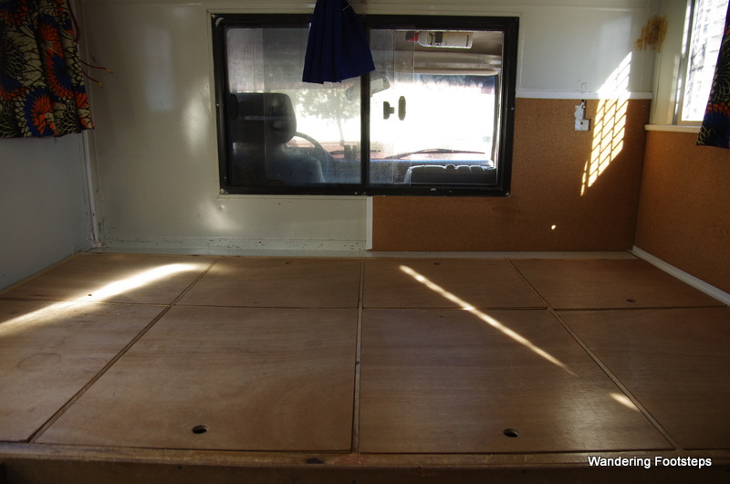 View of the bed frame with storage and window that looks out onto the vehicle's cab.