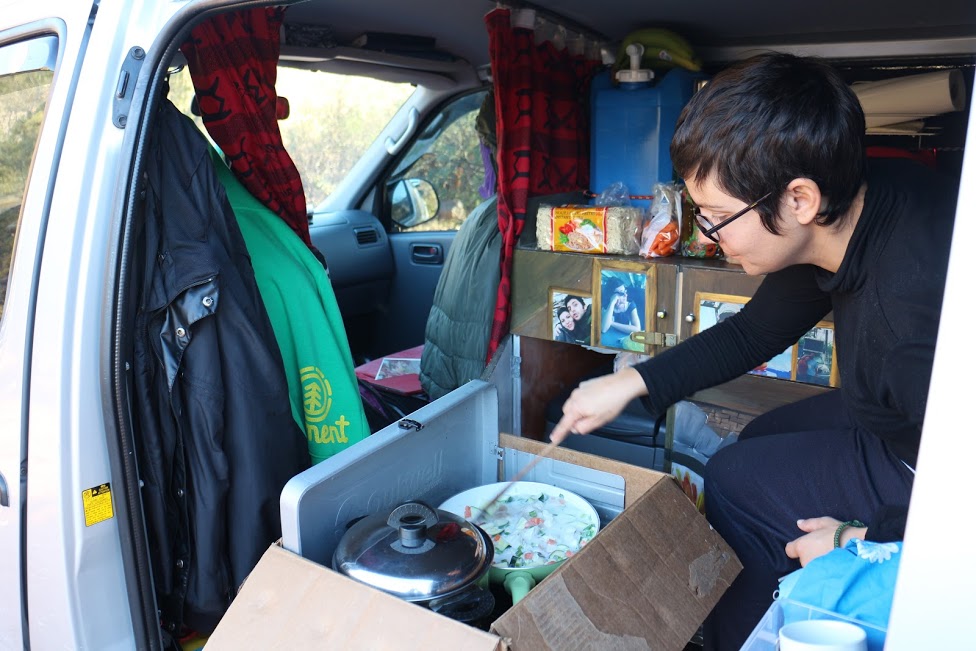 Cooking in their camper van.