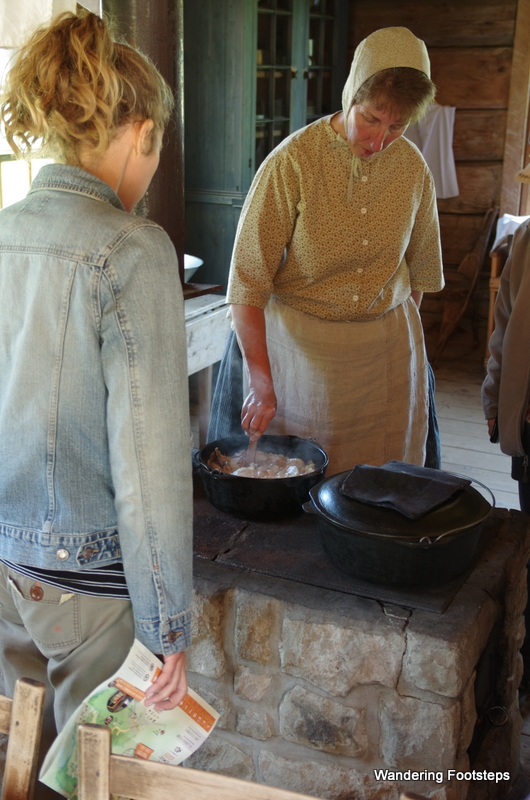 A traditional Acadian chicken stew being slowly brewed in cast iron over a wood fire.  Yum!