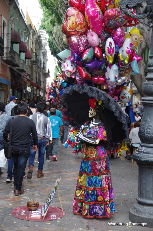 Cinco de Mayo pedestrian street is full of buskers, people, and trinkets for sale.