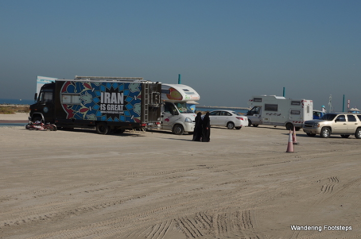 Overlanders parked along a public beach in Dubai.